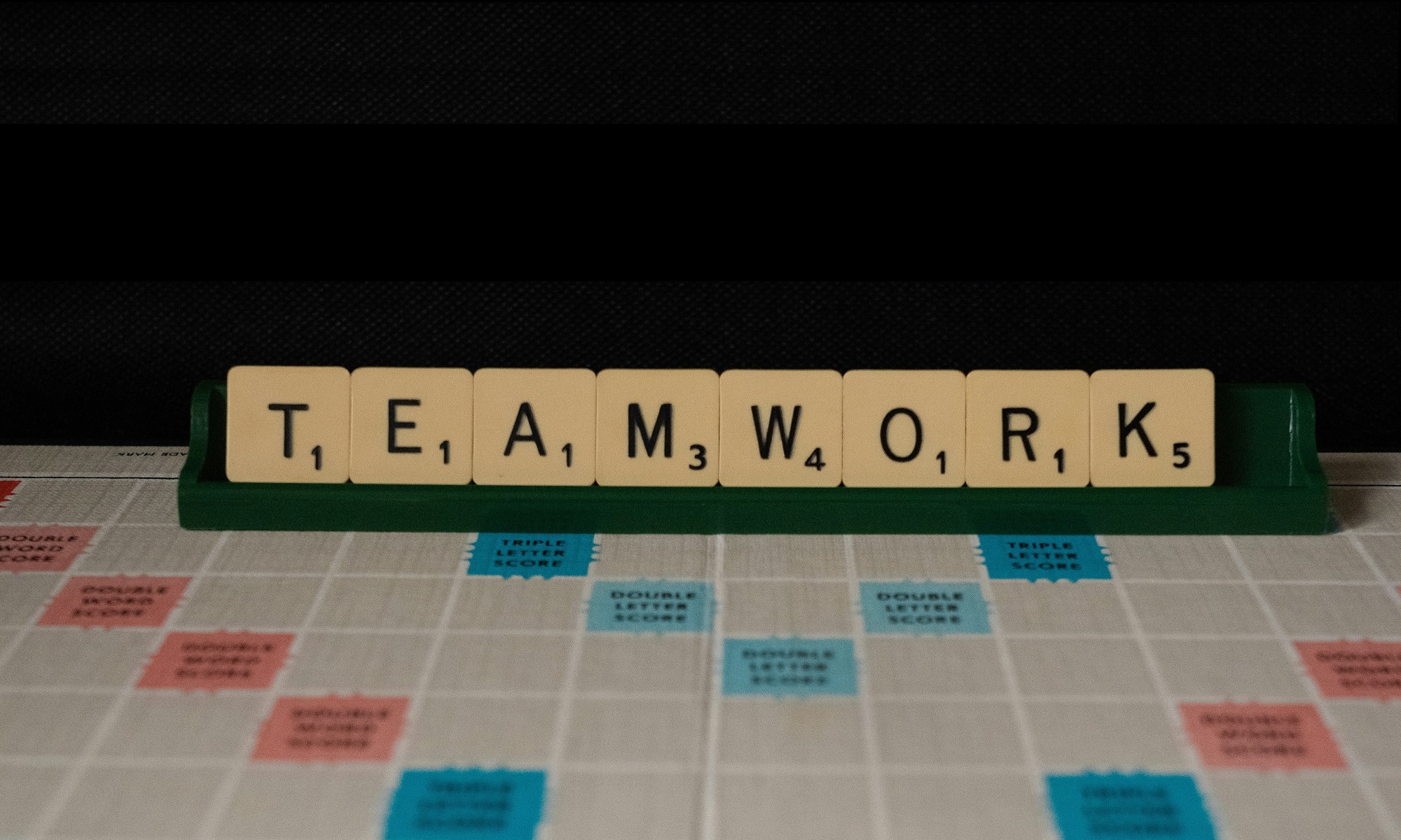 picture of a scrabble tiles above a scrabble board spelling "Teamwork" Newport Baptist Church Leadership