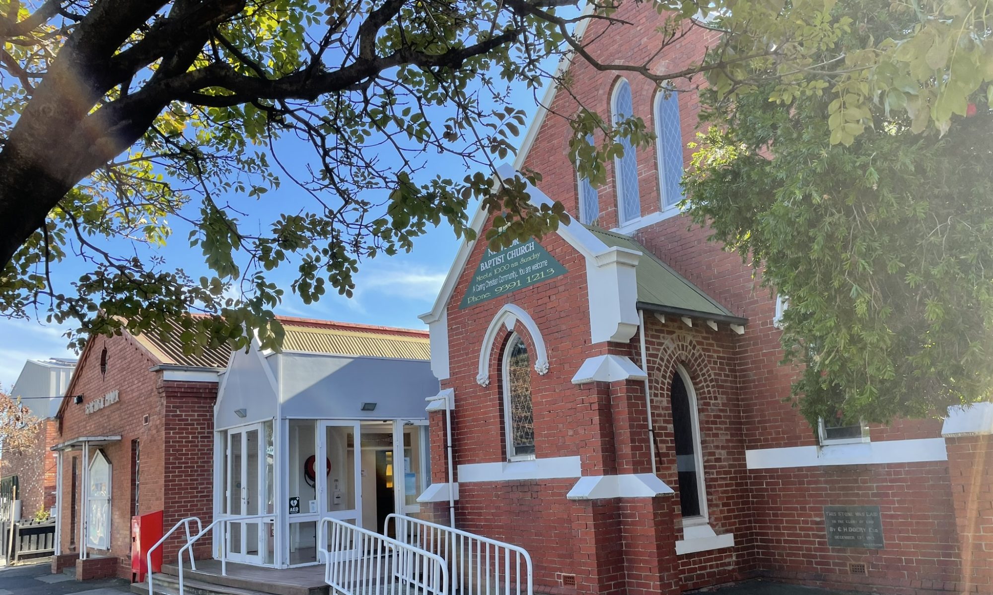 Picture of Newport Baptist Church. A traditional church protestant building beautifully framed by trees